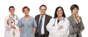 Smiling medical team of nurses, doctors and administrators.