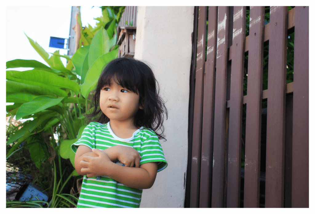 Young girl unconsciously scratching her arms and inside elbow