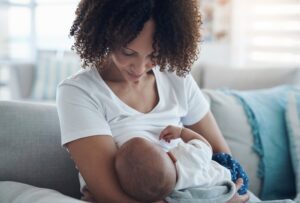 Breastfeeding mum looks down at her baby